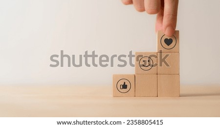 Social media engagement, Digital marketing concept. Stacking the wooden cube blocks with emoticons, creating social media platforms to build relationships and drive sales. Sharing customer experience. Royalty-Free Stock Photo #2358805415