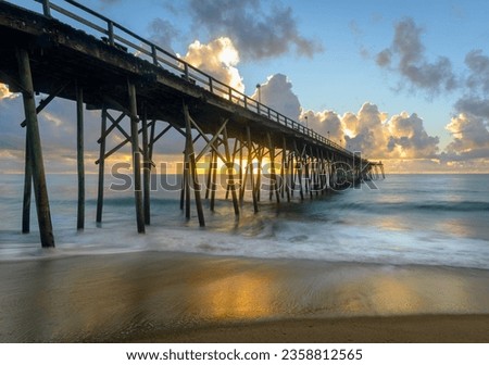 A scenic view of Carolina Beach pier during colorful sunrise, long exposure Royalty-Free Stock Photo #2358812565