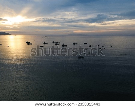 Sea and sky landscape taken from above with Vietnamese fishermen's fishing boats on the turquoise water.  Sea concept, boats.