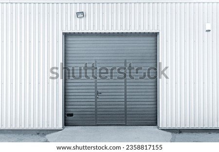 Closed modern steel garage or warehouse doors, colorized industrial picture