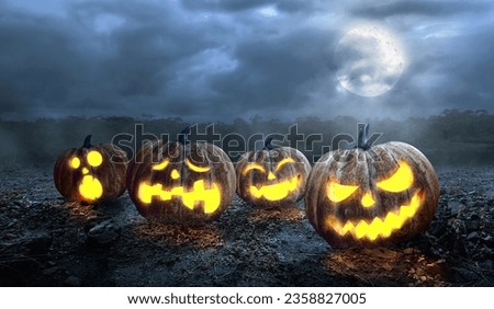 Creepy Halloween pumpkin at night with low spooky fog. Full moon