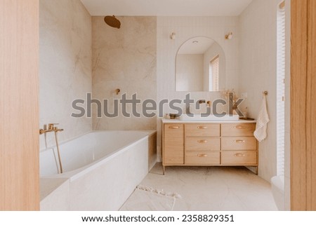 An elegant bathroom with white marble walls and wooden furniture, perfect minimalistic design Royalty-Free Stock Photo #2358829351