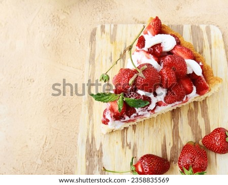 piece of pie with strawberries on a wooden board