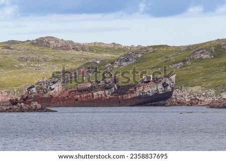 Beautiful landscape of northern nature. Tundra and sea. Old ship.
