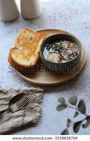 Kacang Pol is a Malaysian famous heritage foods served with egg, kari, and bread in close up shot.