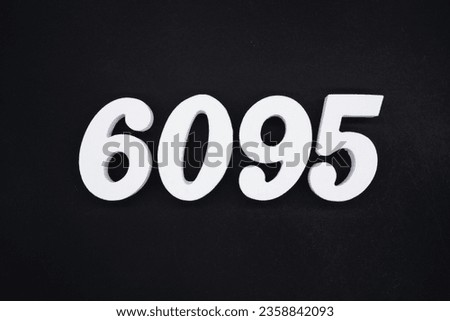 Black for the background. The number 6095 is made of white painted wood.