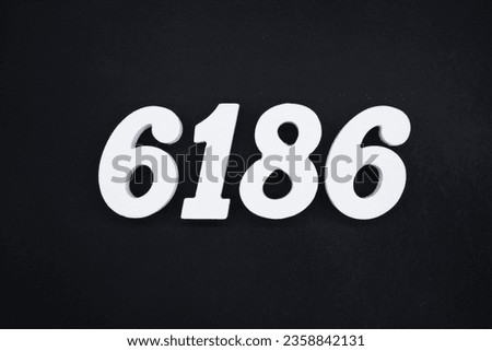 Black for the background. The number 6186 is made of white painted wood.
