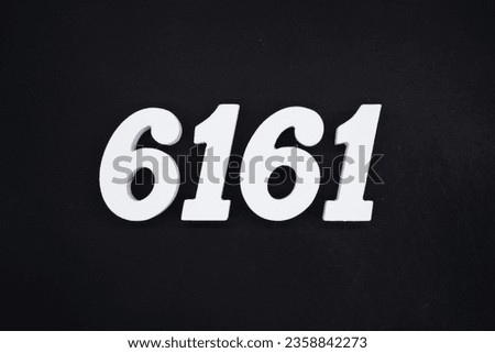 Black for the background. The number 6161 is made of white painted wood.