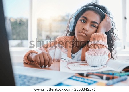 Child, headphones and girl tired of home school, e learning and future online education. Thinking, bored and kid with ADHD, autism and sad at laptop while drawing and listening to audio at table