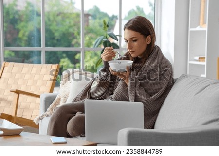 Ill young woman eating chicken soup at home Royalty-Free Stock Photo #2358844789