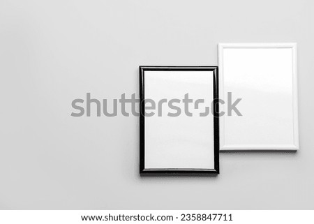 Blank picture frames on light background