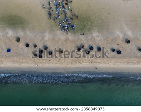Aerial view of beach with basket boats and outdoor seafood market in Da Nang, Vietnam in the morning.  Travel concept, background.