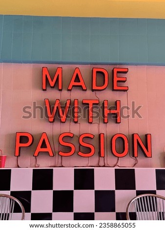A decorative sign in an American retro-style restaurant says "made with passion"