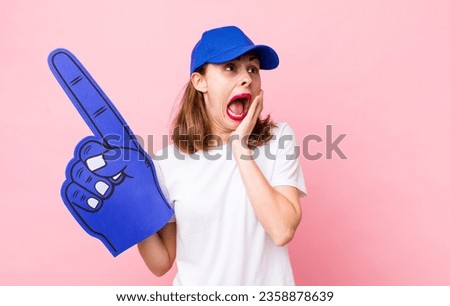young pretty woman  feeling happy, excited and surprised. number one hand fan concept Royalty-Free Stock Photo #2358878639
