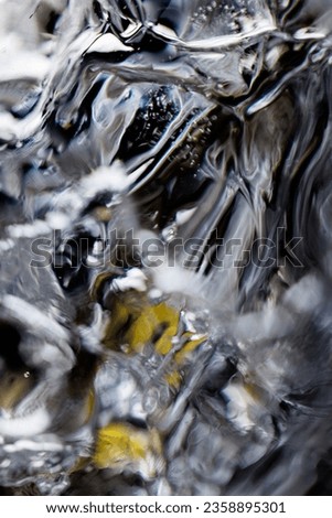 A vertical shot of clear water splashing wave motions