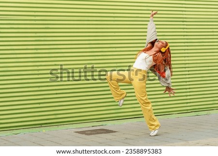 Full size photo of funny lady dance isolated on green color background