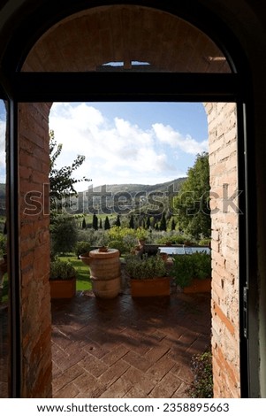 The Italian country landscape is a mesmerizing tapestry of natural beauty and cultural richness. Rolling hills adorned with vineyards and olive groves stretch as far as the eye can see. Royalty-Free Stock Photo #2358895663