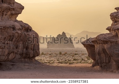 A picturesque desert landscape with rock formations of Tabuk, Neom at sunset Royalty-Free Stock Photo #2358927381