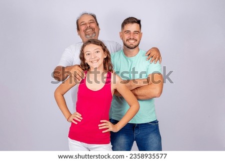 Happy Father's Day. Father with his two children, a teenage girl and an adult boy, on a white background with free space for text. Happy young father and children Royalty-Free Stock Photo #2358935577