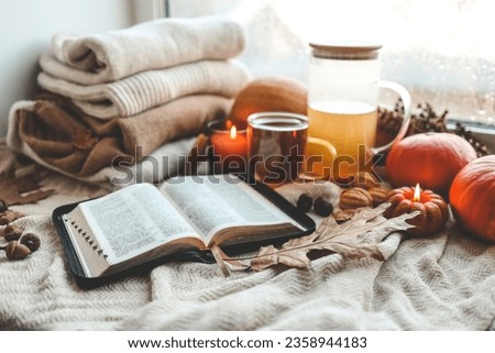 Open bible in autumn interior, good morning.