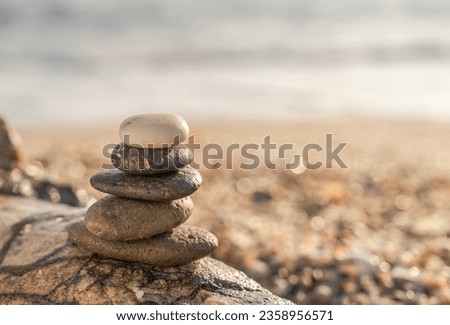Stone Stack on rock beach sea beach in the morning sunrise, Sign of Zen with nature meditation Buddhism  Royalty-Free Stock Photo #2358956571