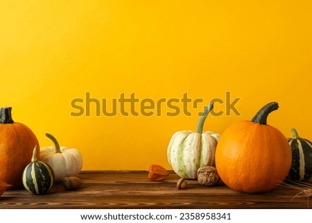 Get into the harvest spirit! Side view shot of a wooden table adorned with a variety of autumn treasures, like pumpkins, pattypans, walnut, physalis, acorn, wheat set against warm, inviting background