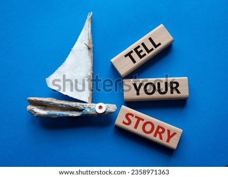Tell your story symbol. Wooden blocks with words Tell your story. Beautiful blue background with boat. Business and Tell your story concept. Copy space.