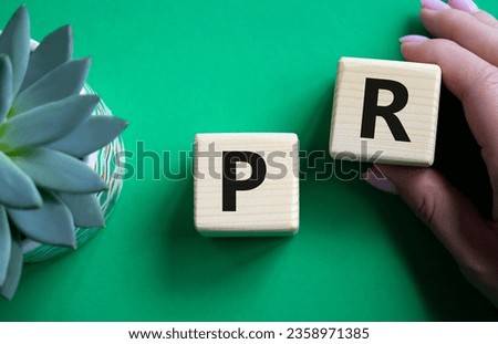 Ok symbol. Concept word Ok on wooden cubes. Businessman hand. Beautiful green background with succulent plant. Business and Ok concept. Copy space.