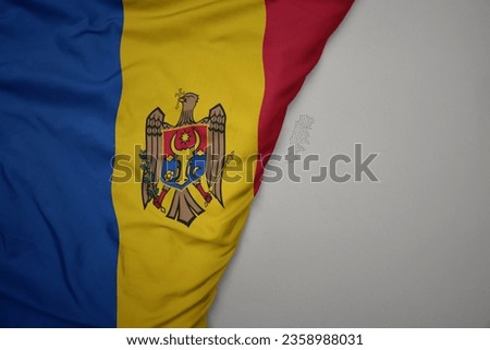 big waving national colorful flag of moldova on the gray background. macro