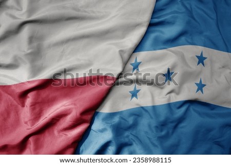 big waving national colorful flag of poland and national flag of honduras . macro
