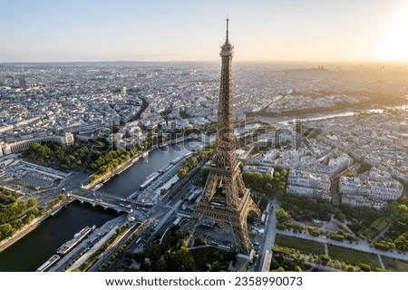 Aerial view of the Eiffel Tower and the Seine River with the city of Paris, France in the background at sunrise.
