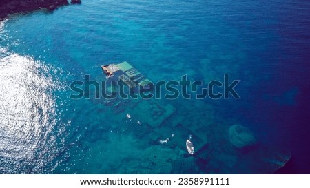 Aerial view of people swimming above sunken shipwreck of cargo ship Boka, now tourist attraction, near town of Orebic, Croatia on Peljesac peninsula