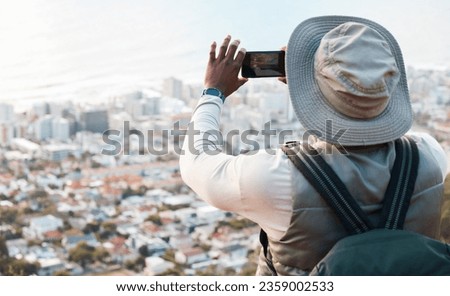 Phone, hiking and photography of man in city, adventure and travel on holiday vacation. Mobile, picture of town and person trekking outdoor, journey and back view of urban landscape on smartphone