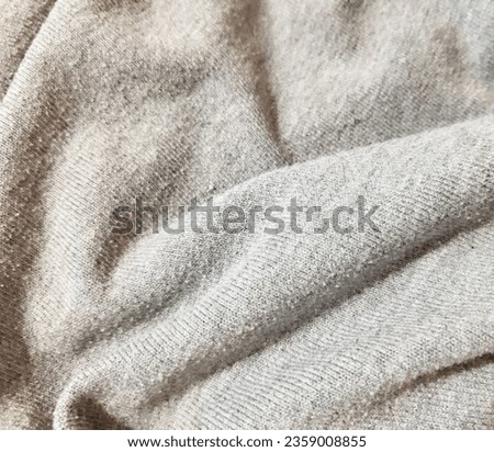 Gray light cosy warm knitted material. Background design, photography. Textile, fabric template,  modern new