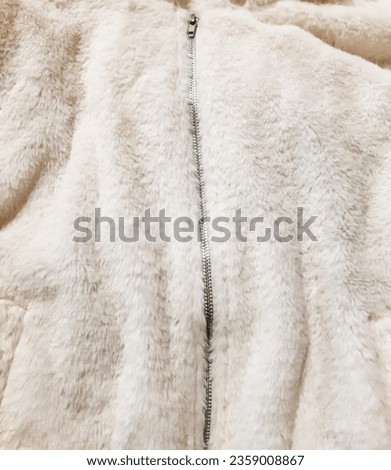 Fluffy faux fur cloth with zip lock. Warm, cozy, soft, fluffy. Background design, photography. Textile, fabric template,  modern new