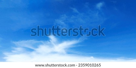Beautiful blue sky atmosphere and white clouds of various shapes with sunlight. Nature background Royalty-Free Stock Photo #2359010265