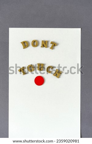 decorative sign with message: don't touch and red circle on paper