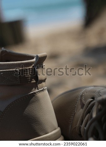 photo of a pair of shoes on the beach. An abstract photo of a pair of shoes suitable for use as a background. summer theme color.