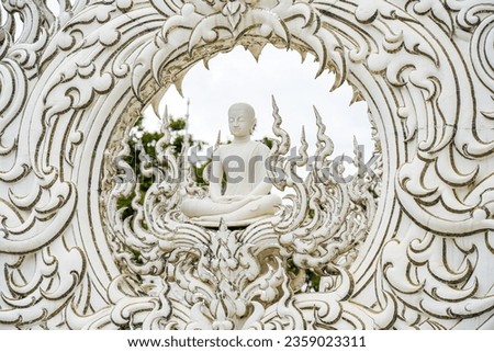 Buddha Monk at the White Temple also known as Wat Rongkhun, located in Chiang Rai, Thailand. Designed by master Chalermchai Kositpipat. It is one of the most visited attractions in Northern Thailand. Royalty-Free Stock Photo #2359023311