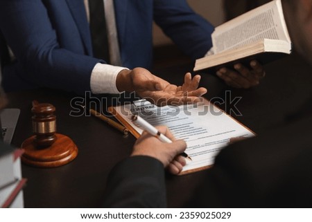 Lawyer reads law code, studies constitution to protect human rights before business contract signing, male lawyer or judge working with hammer of justice law book