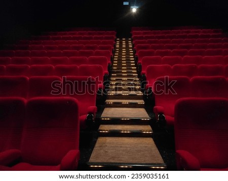 row of red seats in movie theater Royalty-Free Stock Photo #2359035161