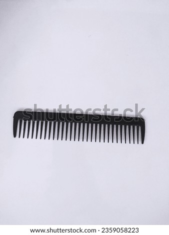 A comb is a tool made of hard material, usually flat, with teeth, and used to style hair, straighten and clean it, or to use for other fibers.
