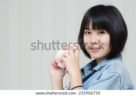Asian teenager with fashion camera.