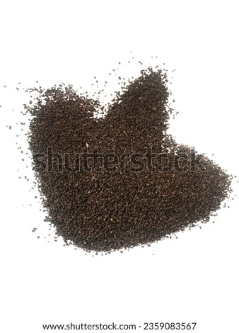 A pile of brown gravel shaped object made of tea leaf powder isolated on white background.