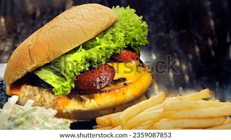 Fresh burger and french fries in black background Angus dynamite beef burger