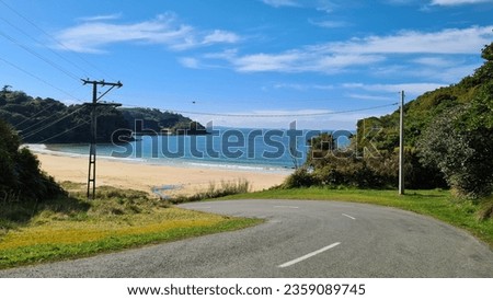 Road curving towards sandy beach Royalty-Free Stock Photo #2359089745
