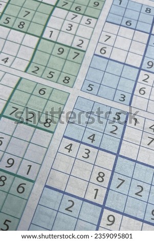 Close-up of a table with numbers and a crossword puzzle. Sudoku.