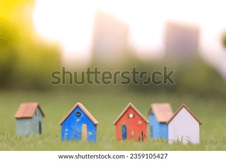 Small residential toy house on blur background. Create a house concept.