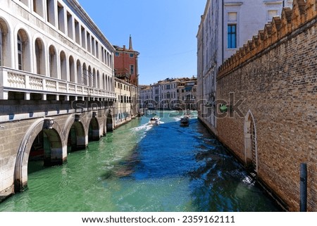 Diminishing view of channel with water taxis at Ca' Foscari University on a sunny summer day at Italian City of Venice. Photo taken August 8th, 2023, Venice