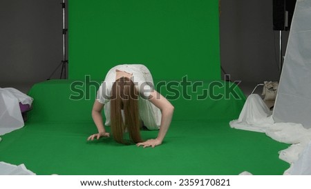 Full-size green screen chroma key shot of a posessed female, woman figure, ghost, poltergeist, zombie crawling towards the camera, hunched. The ring reference. Chroma key.